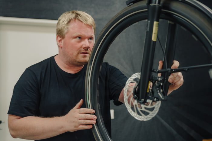 Man holding bikes front wheel